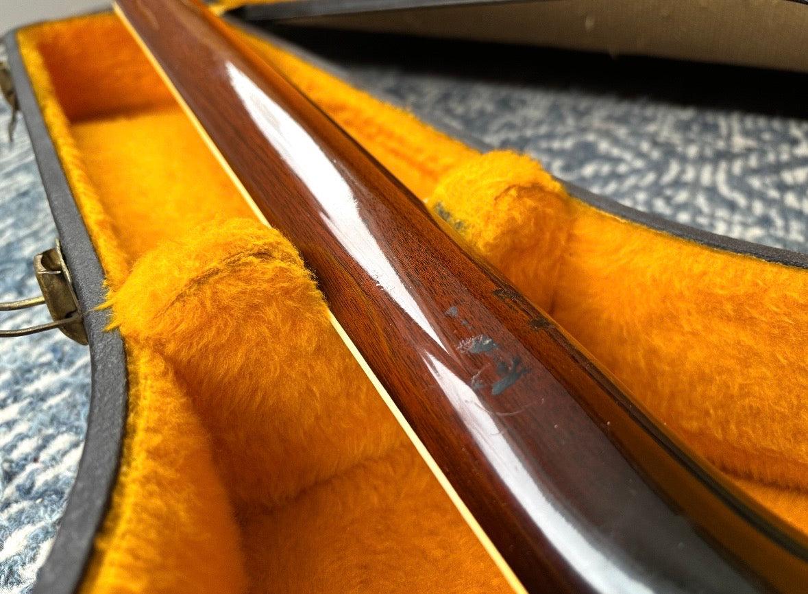 one mark on the back of the neck (pictured) probably from a Capo, that is not easily felt when playing up the neck